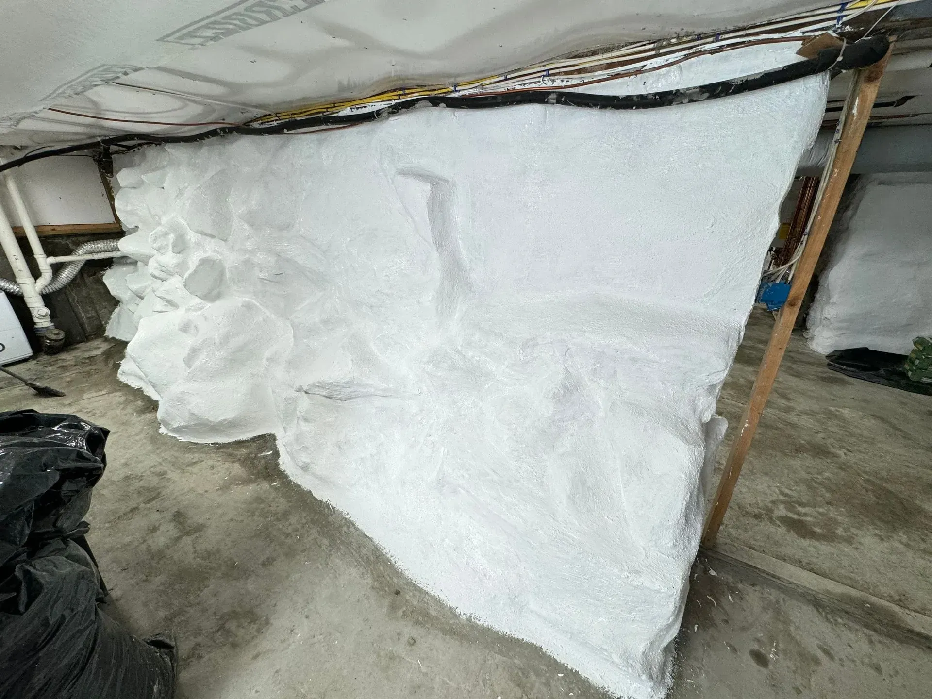 White textured wall under construction with wood supports.