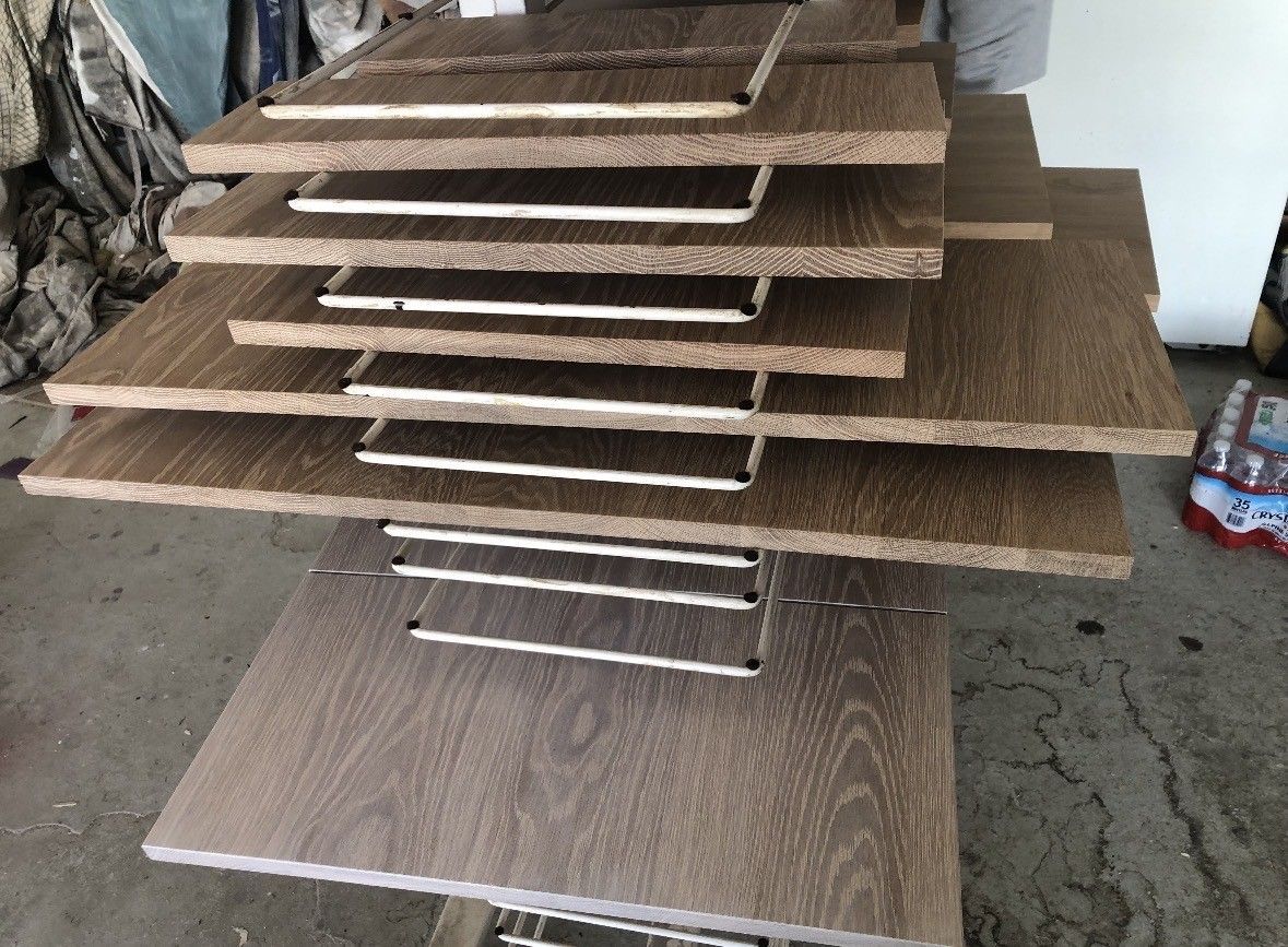Stack of brown wood panels with white supports.
