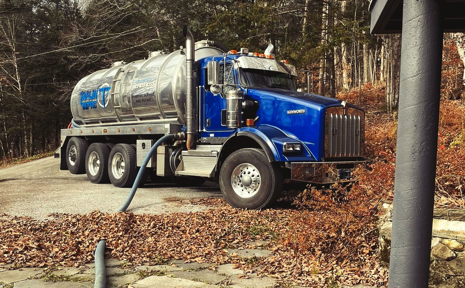 A Taplin Septic truck in fall setting.