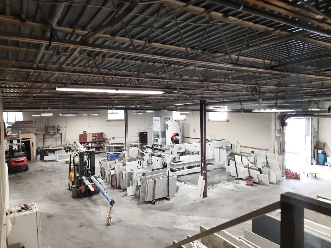 a large warehouse with a forklift in the middle of it