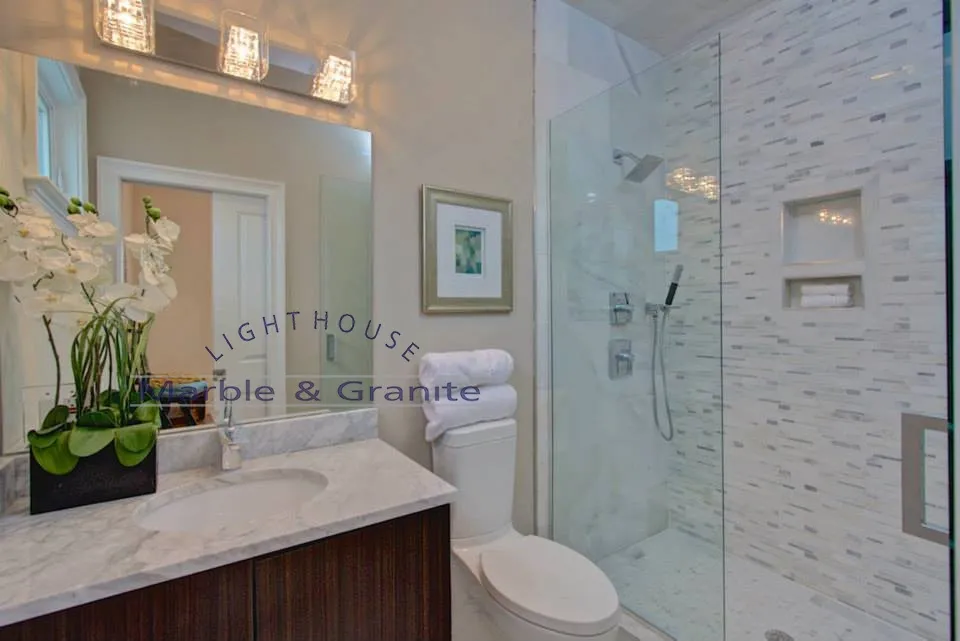 a bathroom with a toilet, sink, mirror and walk in shower