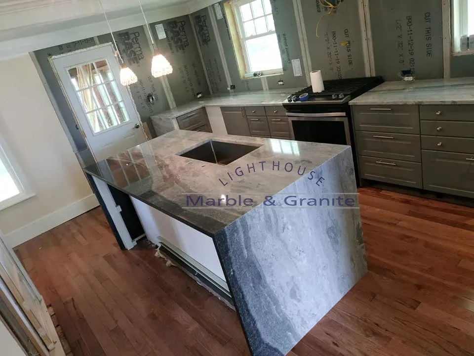 a kitchen with a large island in the middle of it