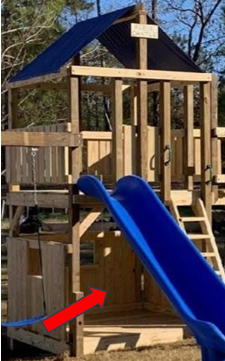 A wooden playhouse with a blue slide and lower clubhouse