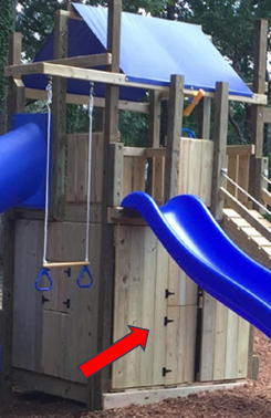 A wooden playhouse with a blue slide and lower clubhouse