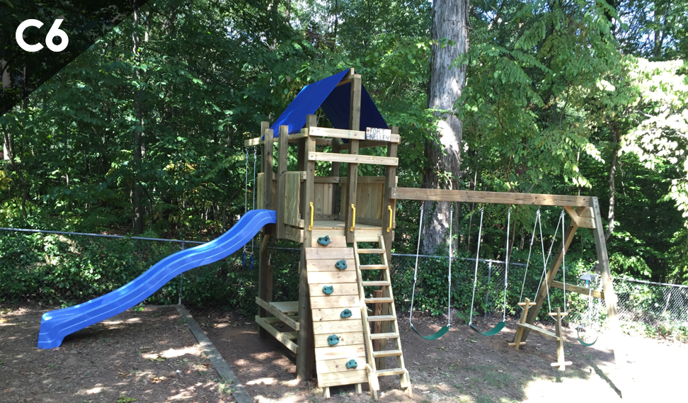 A wooden playground with a blue slide and stairs