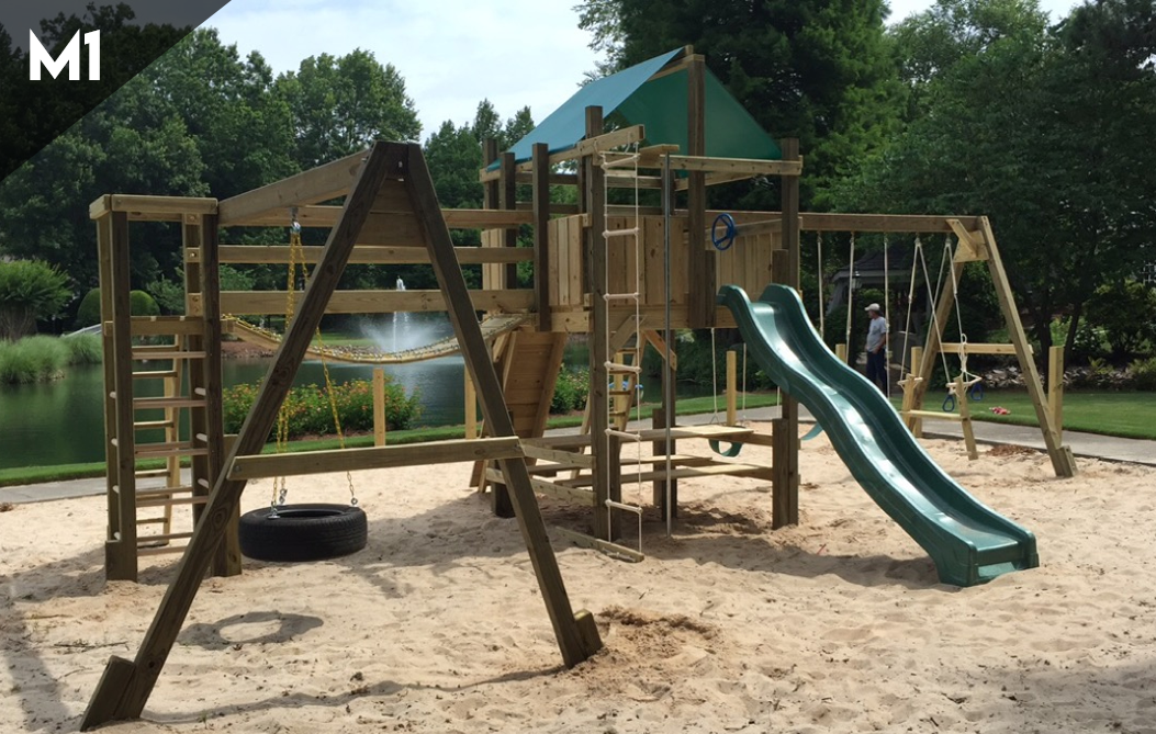 A wooden playground with a slide and swings in a park.