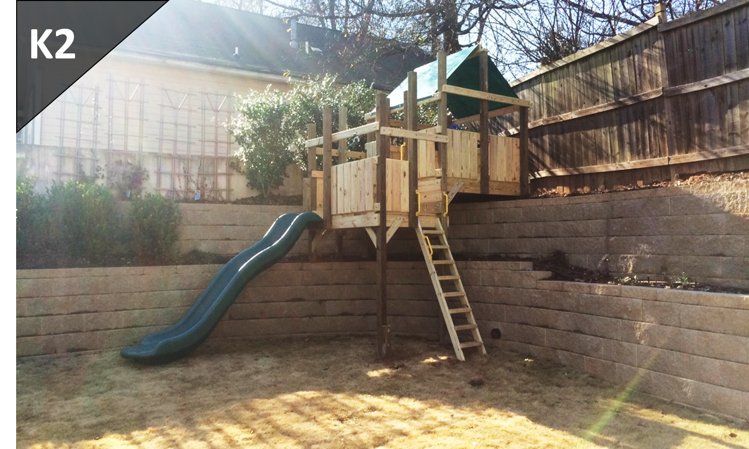 A wooden playground with a slide and stairs in a backyard