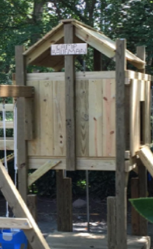 A wooden playhouse with a sign that says house on it