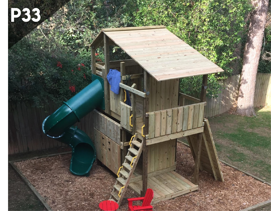 A wooden playground with a green slide and stairs