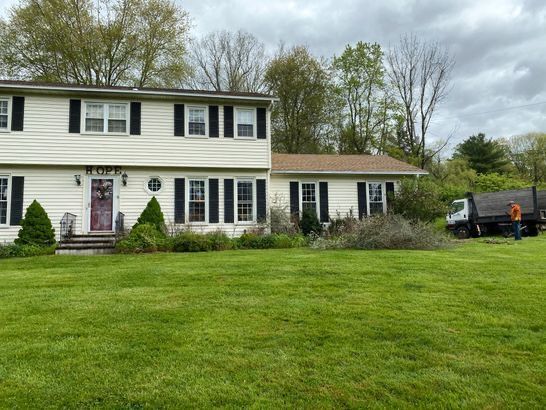 A large white house with a large lawn in front of it.