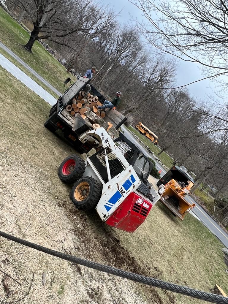 A couple of tractors are parked next to each other on the side of the road.