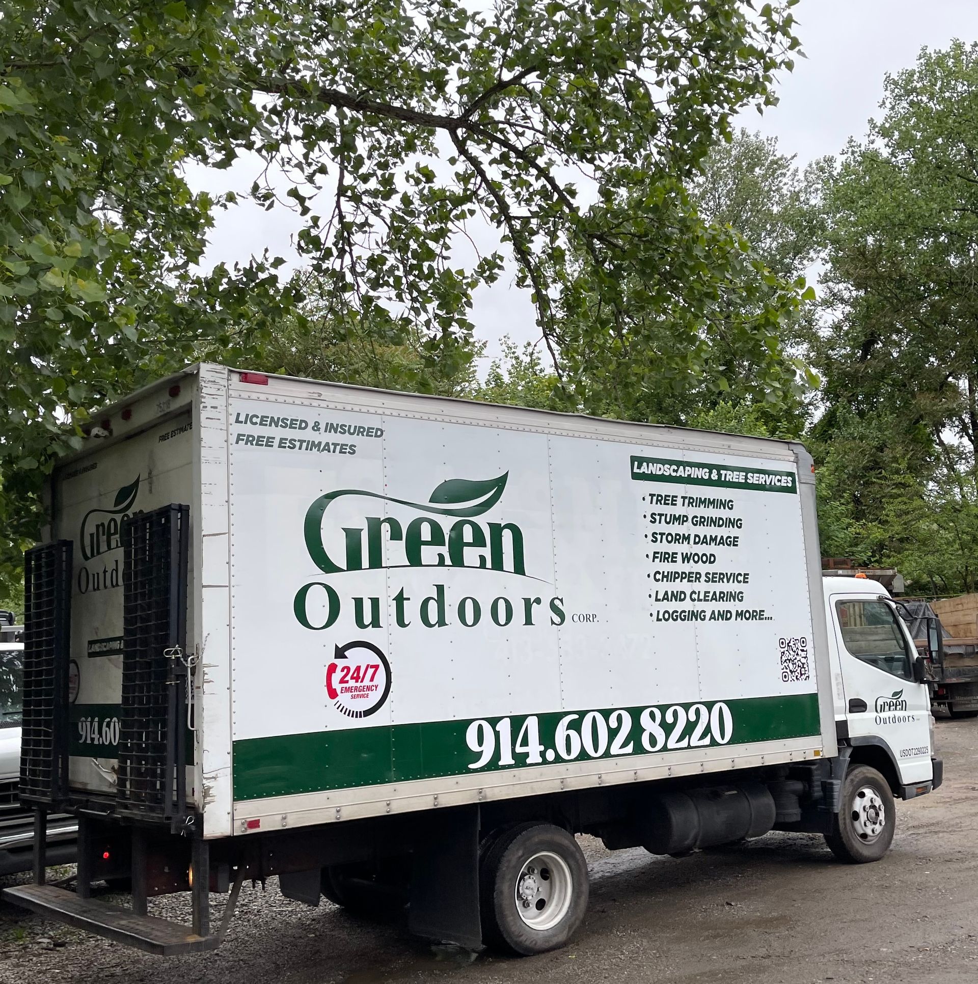 A green outdoors truck is parked on the side of the road