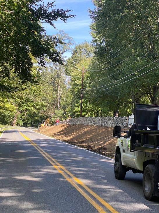 A dump truck is parked on the side of the road