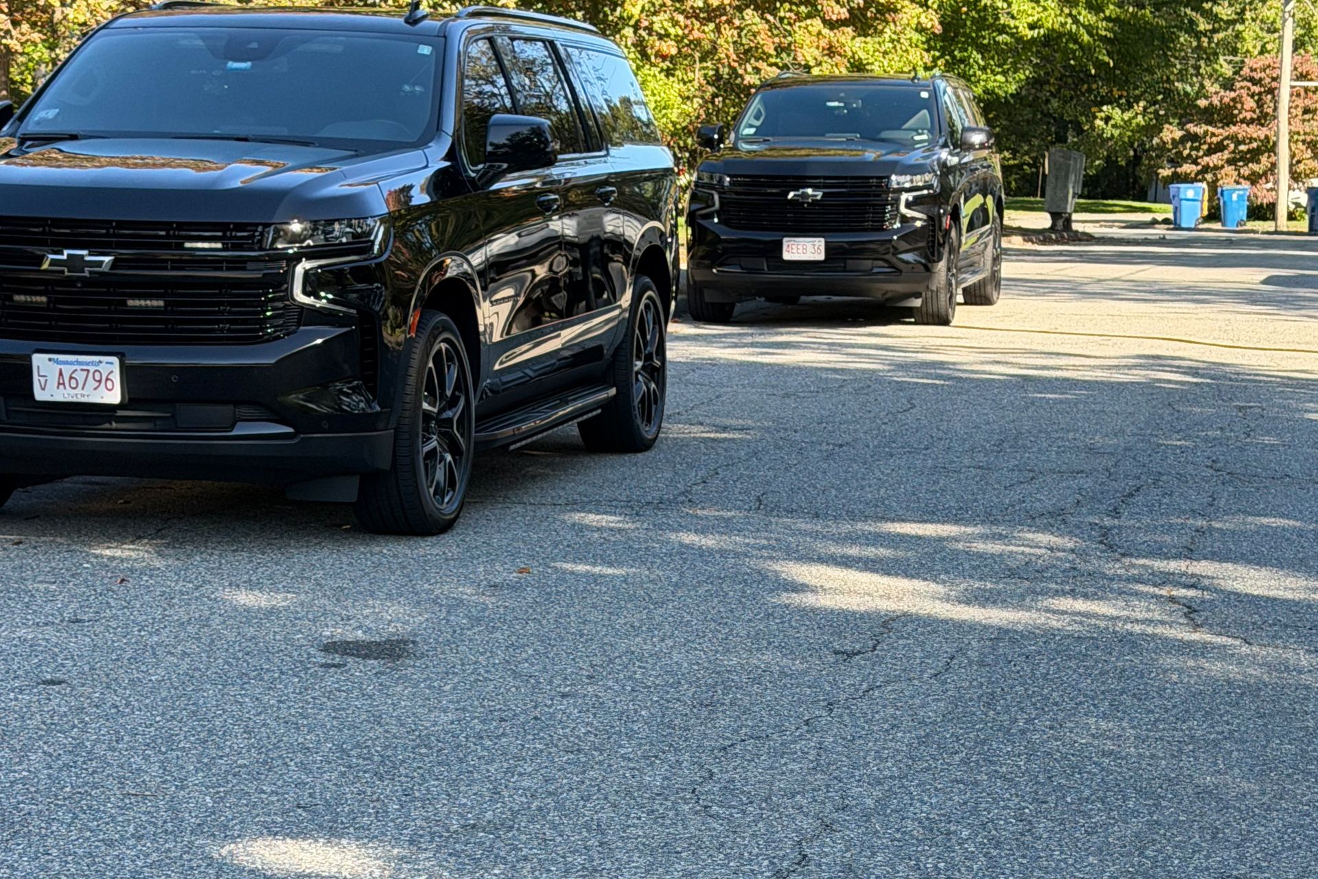 Black SUVs parked on a car lot on a sunny day