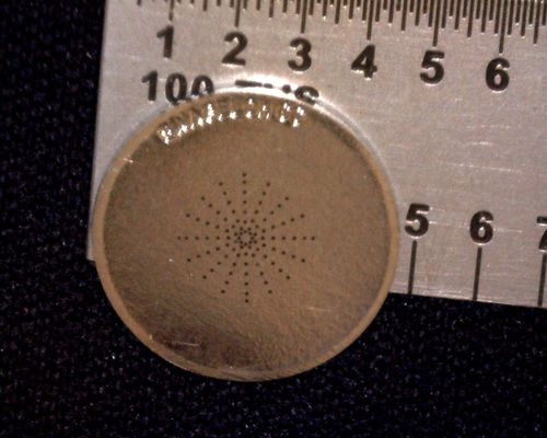 EDM machine precision-drilling a metal disk .006