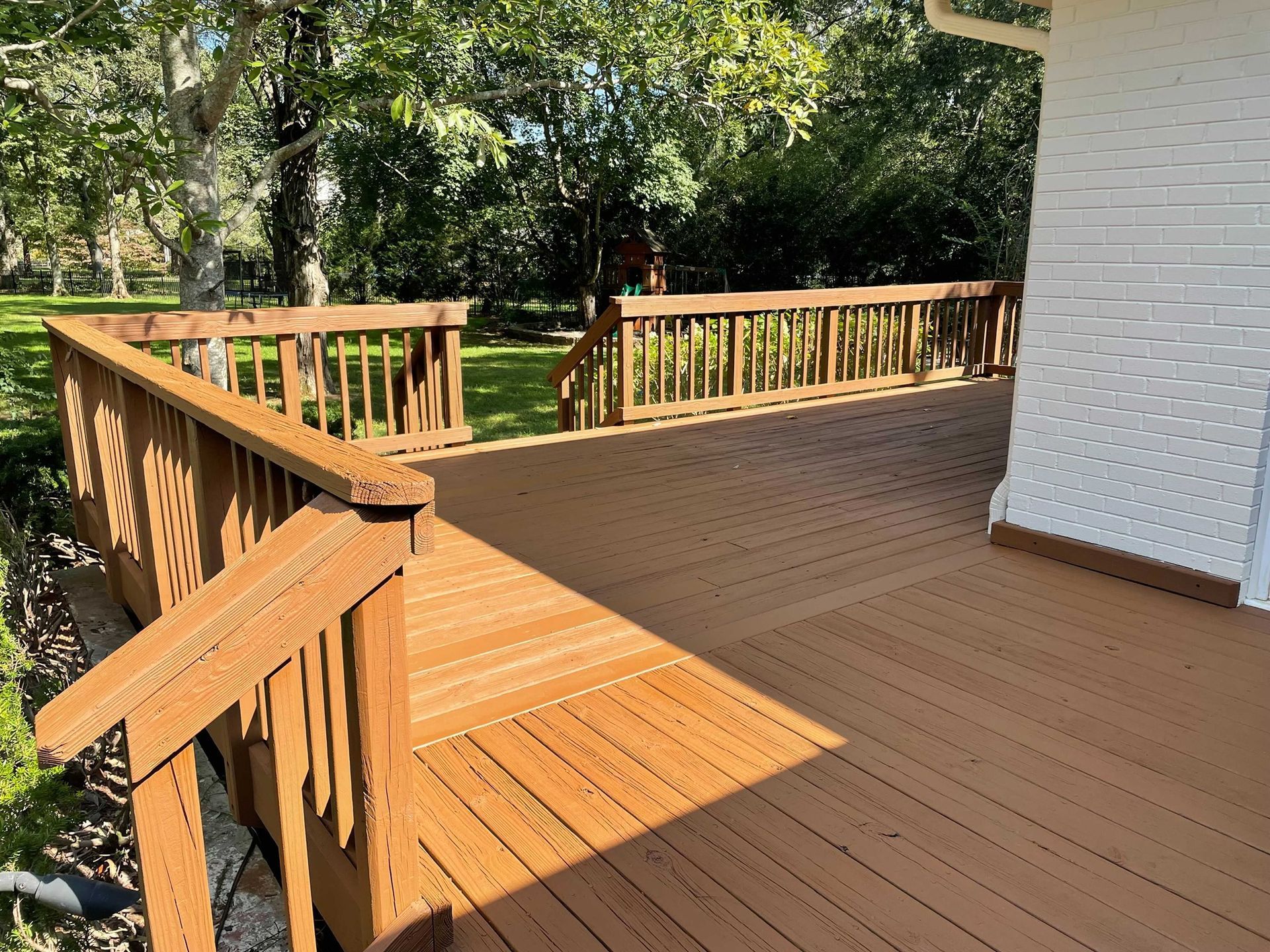 A large wooden deck with stairs leading up to it