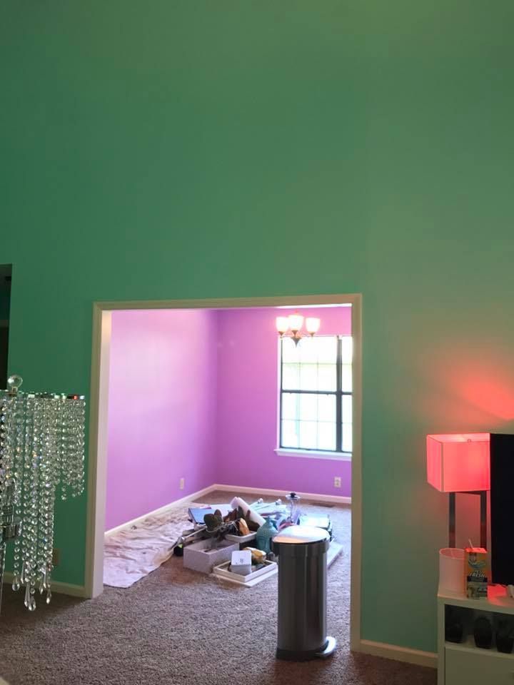 A living room with green walls and purple walls