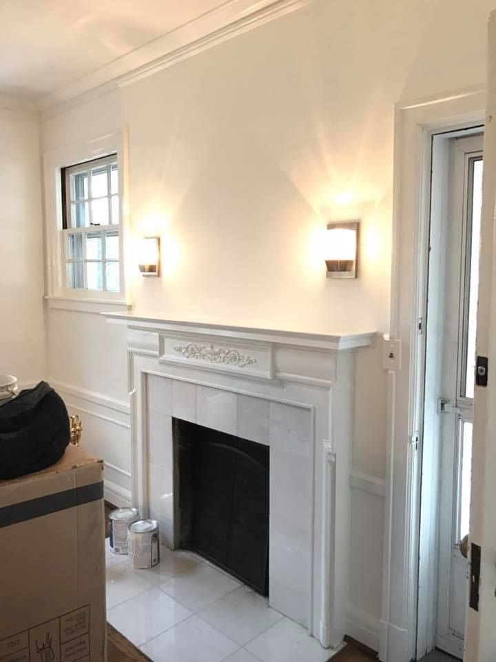 A living room with a fireplace and a door.