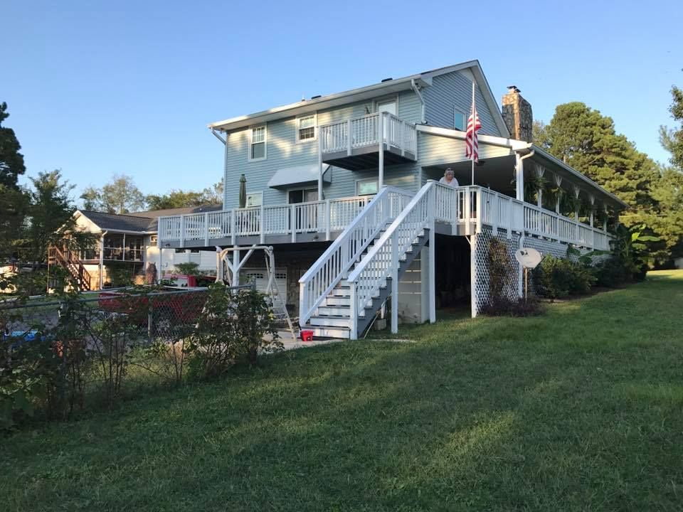 A large house with a large deck and stairs