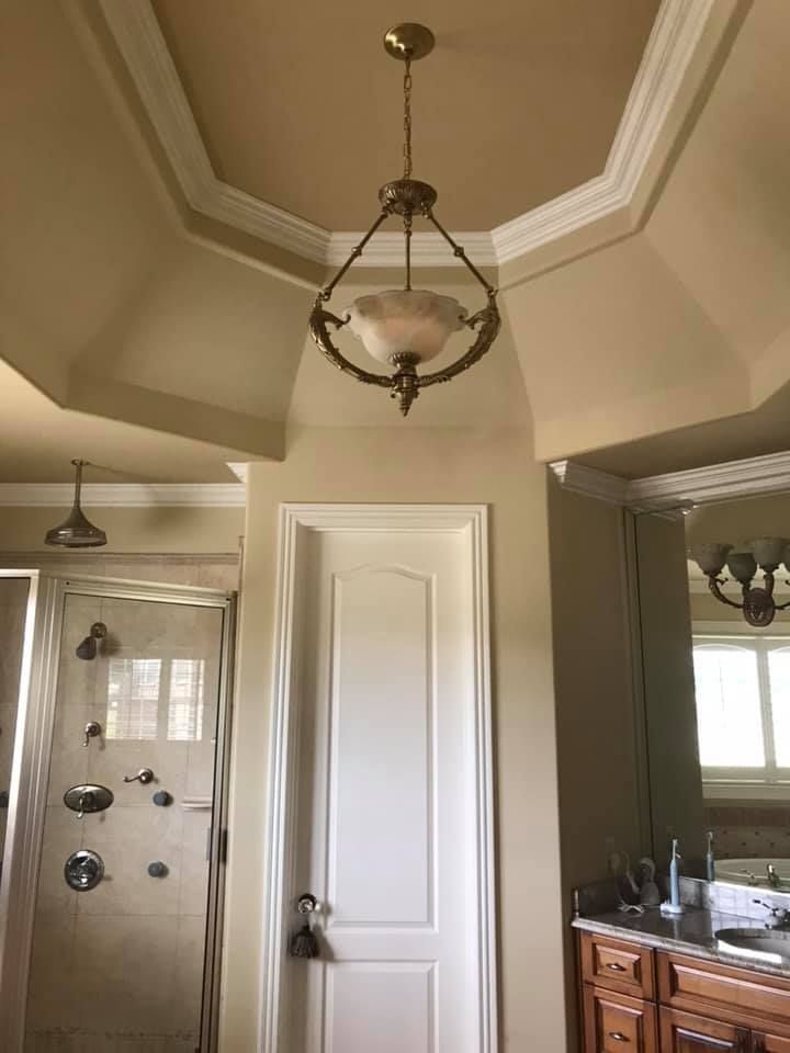 A bathroom with a chandelier hanging from the ceiling.