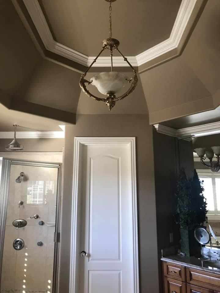 A bathroom with a chandelier hanging from the ceiling.