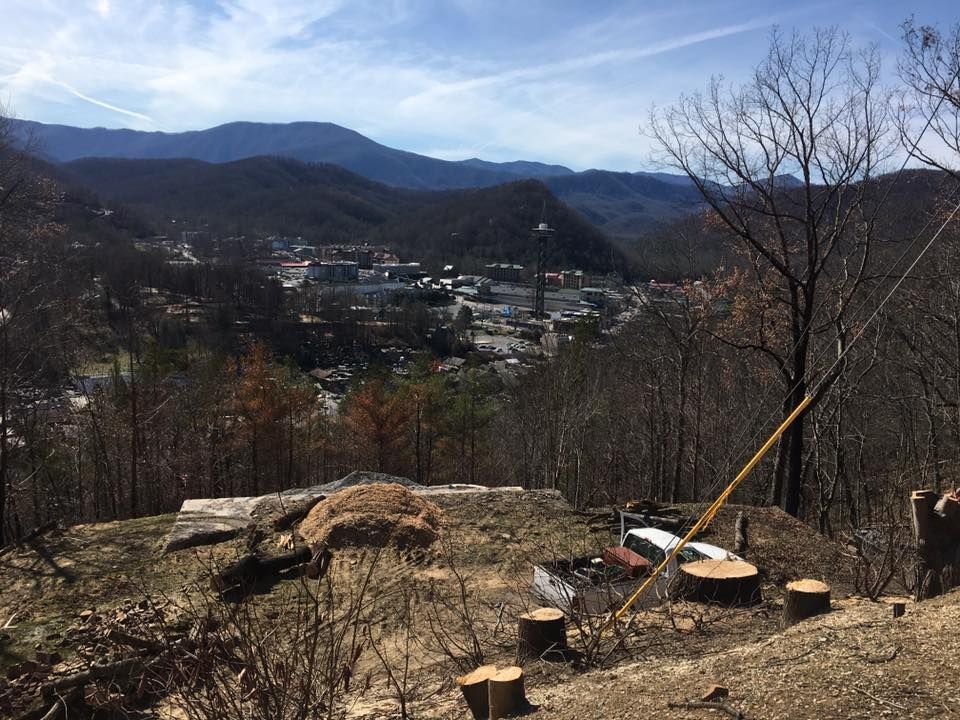 a view of a city from the top of a hill in the mountains