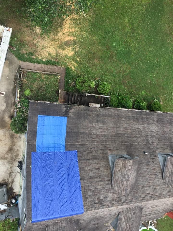 an aerial view of a roof with a blue tarp on it