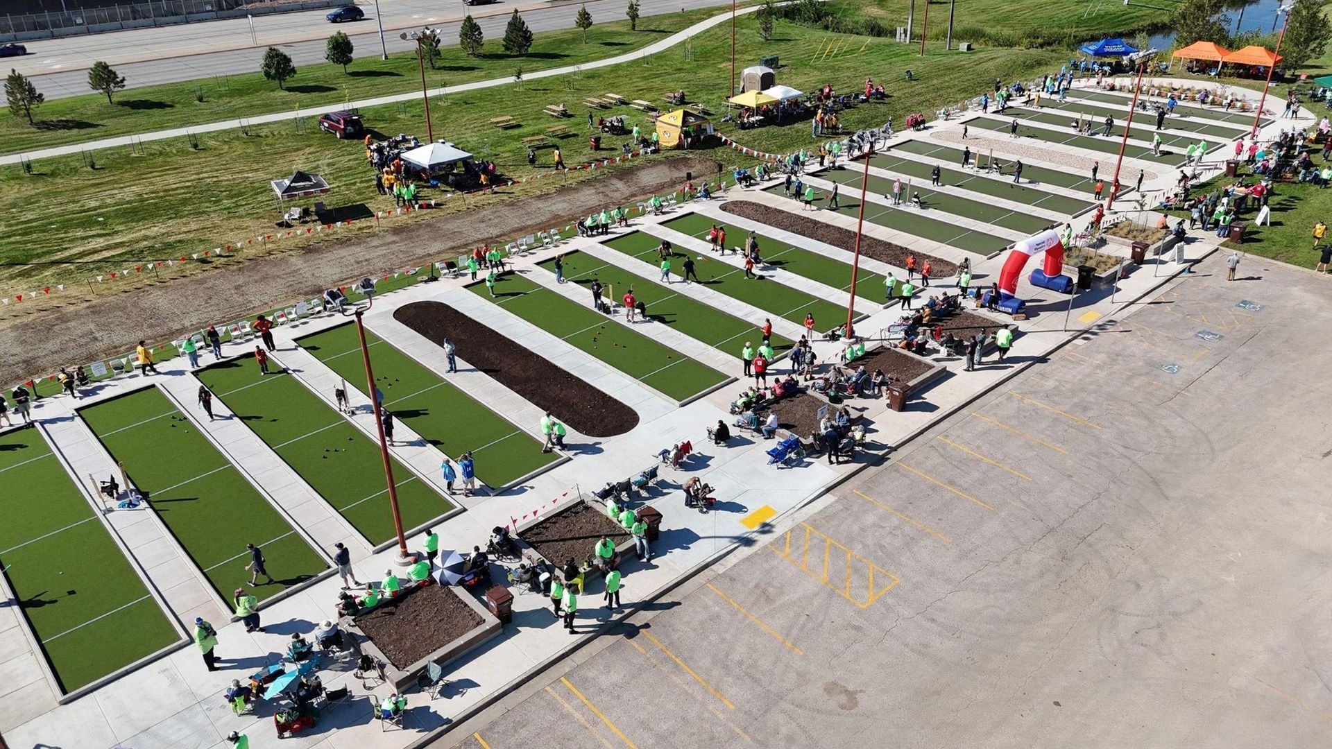 Aerial view of a bocce ball tournament on artificial turf courts