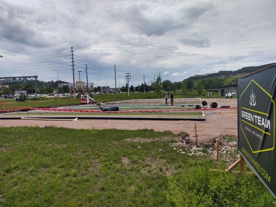 Construction site with green turf installation