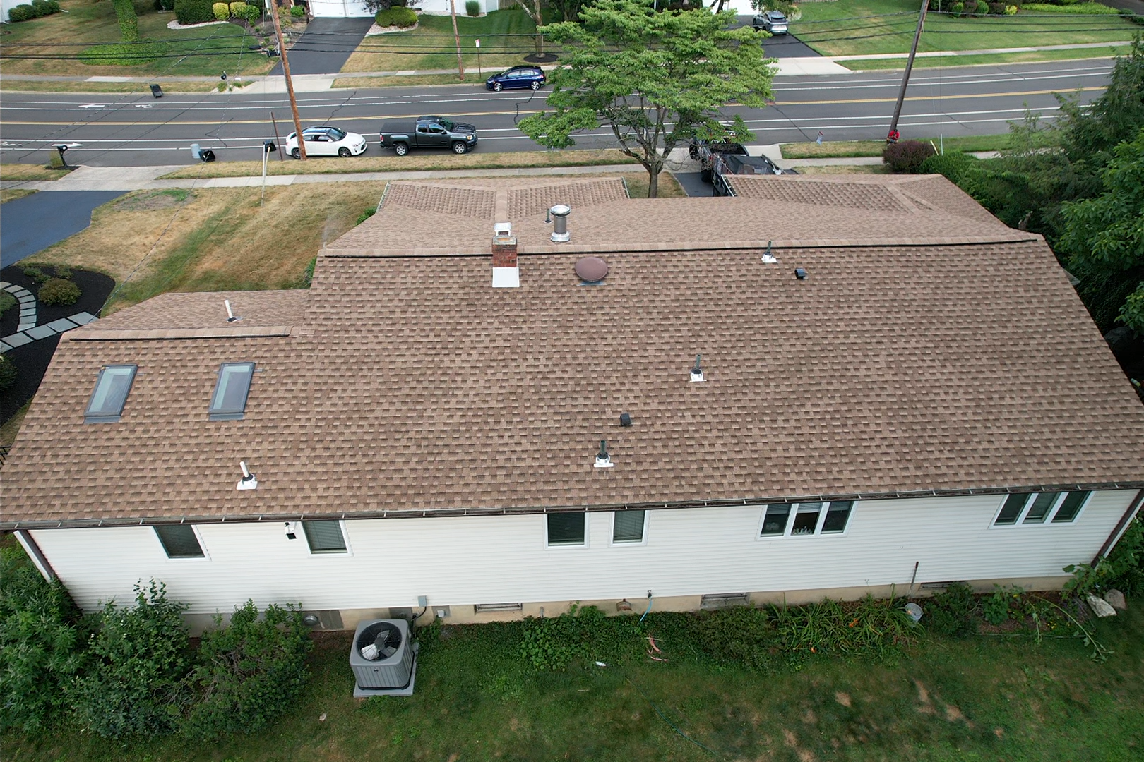 An aerial view of a house with a brown roof