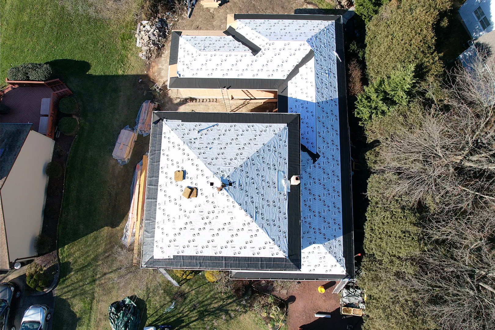 An aerial view of a house with a roof being installed