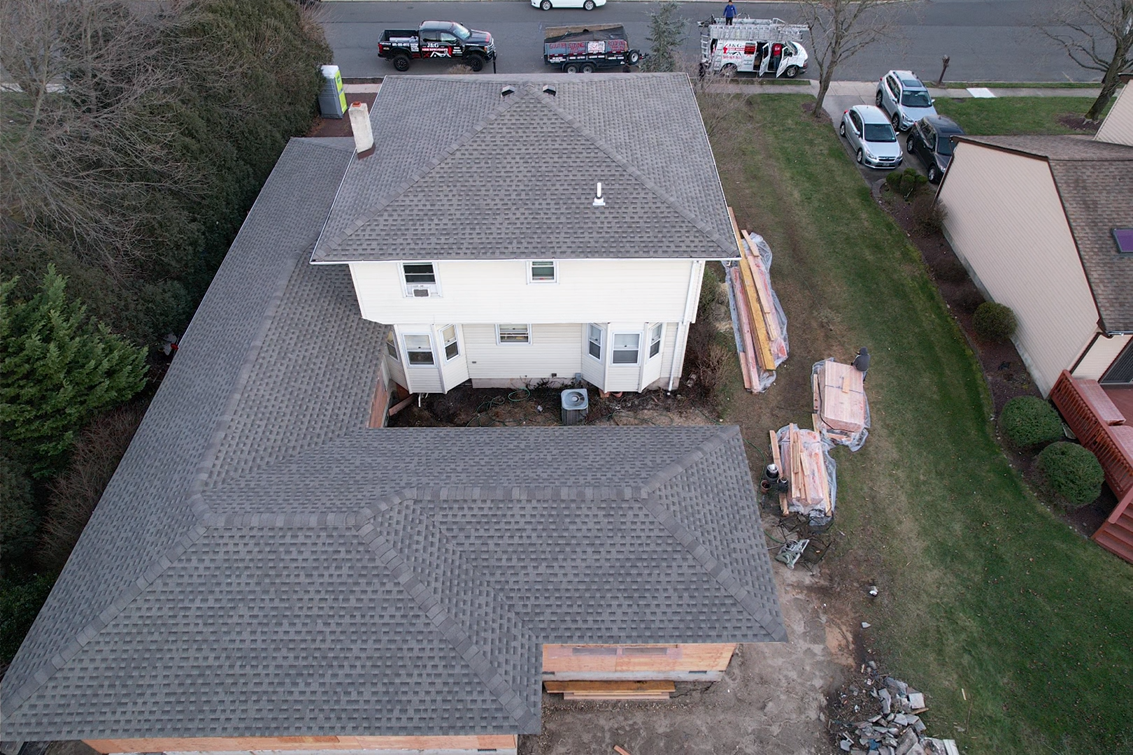 An aerial view of a house under construction with a gray roof