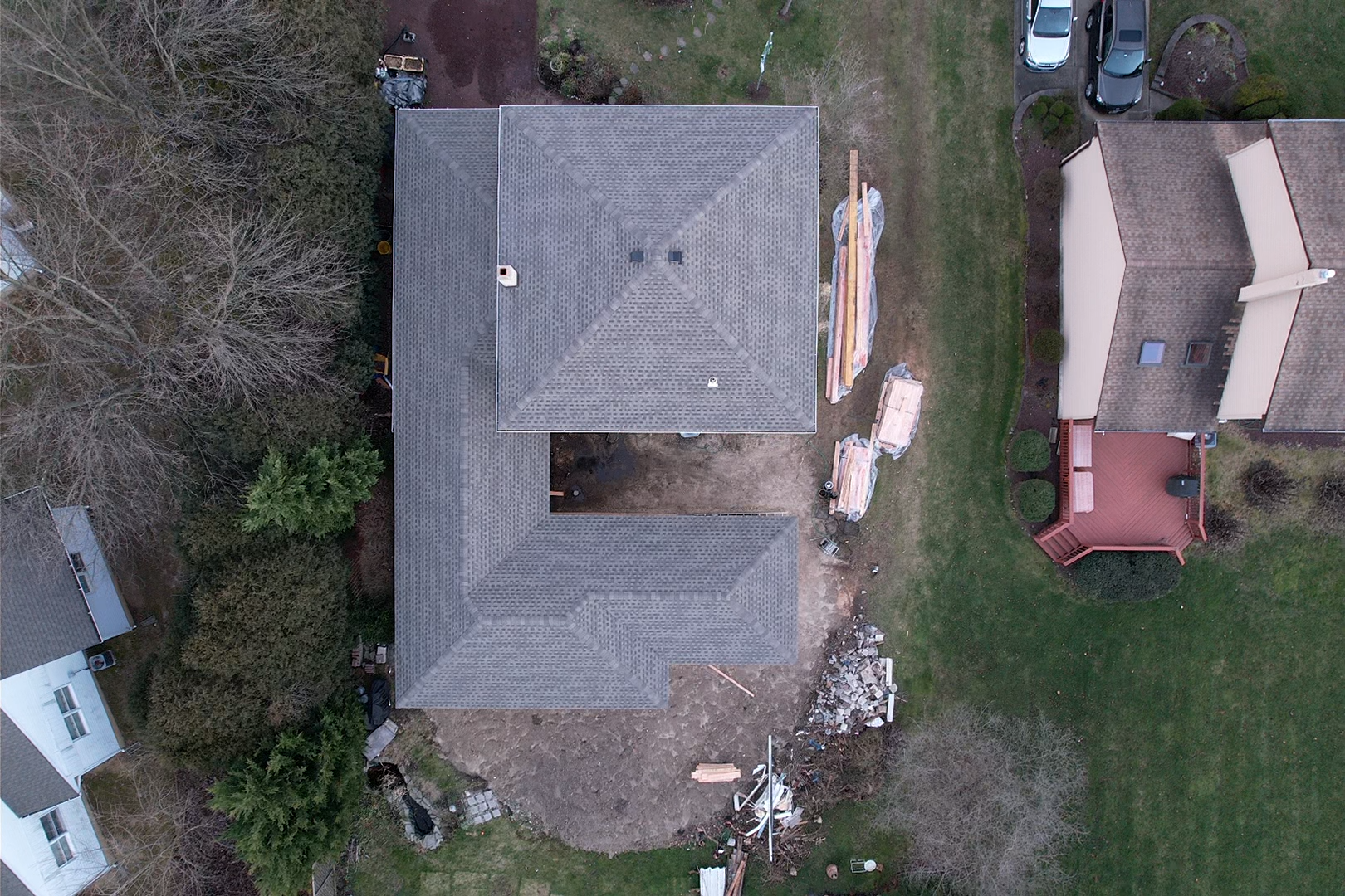 An aerial view of a house under construction in a residential area