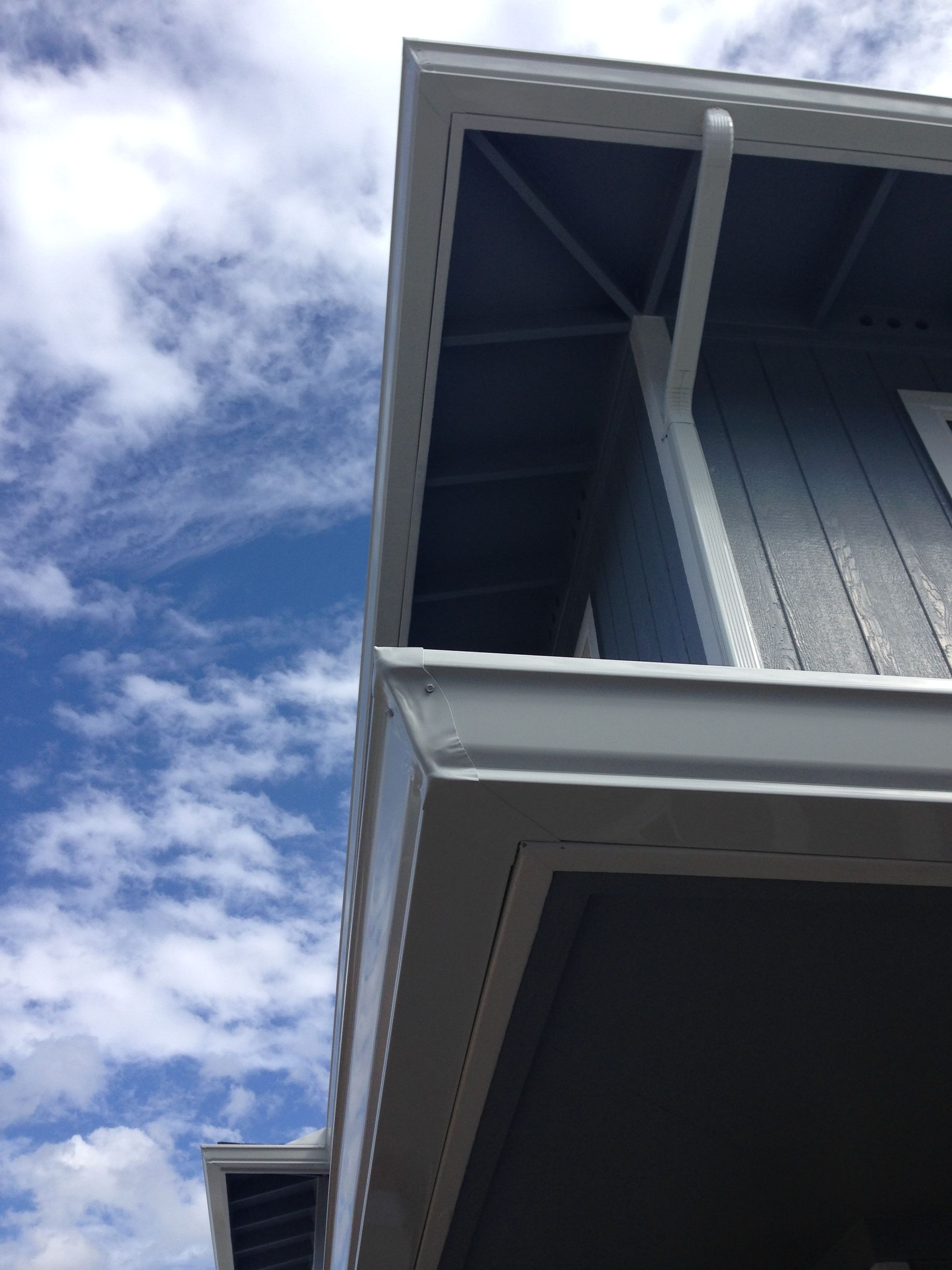 Blue sky with clouds and a house