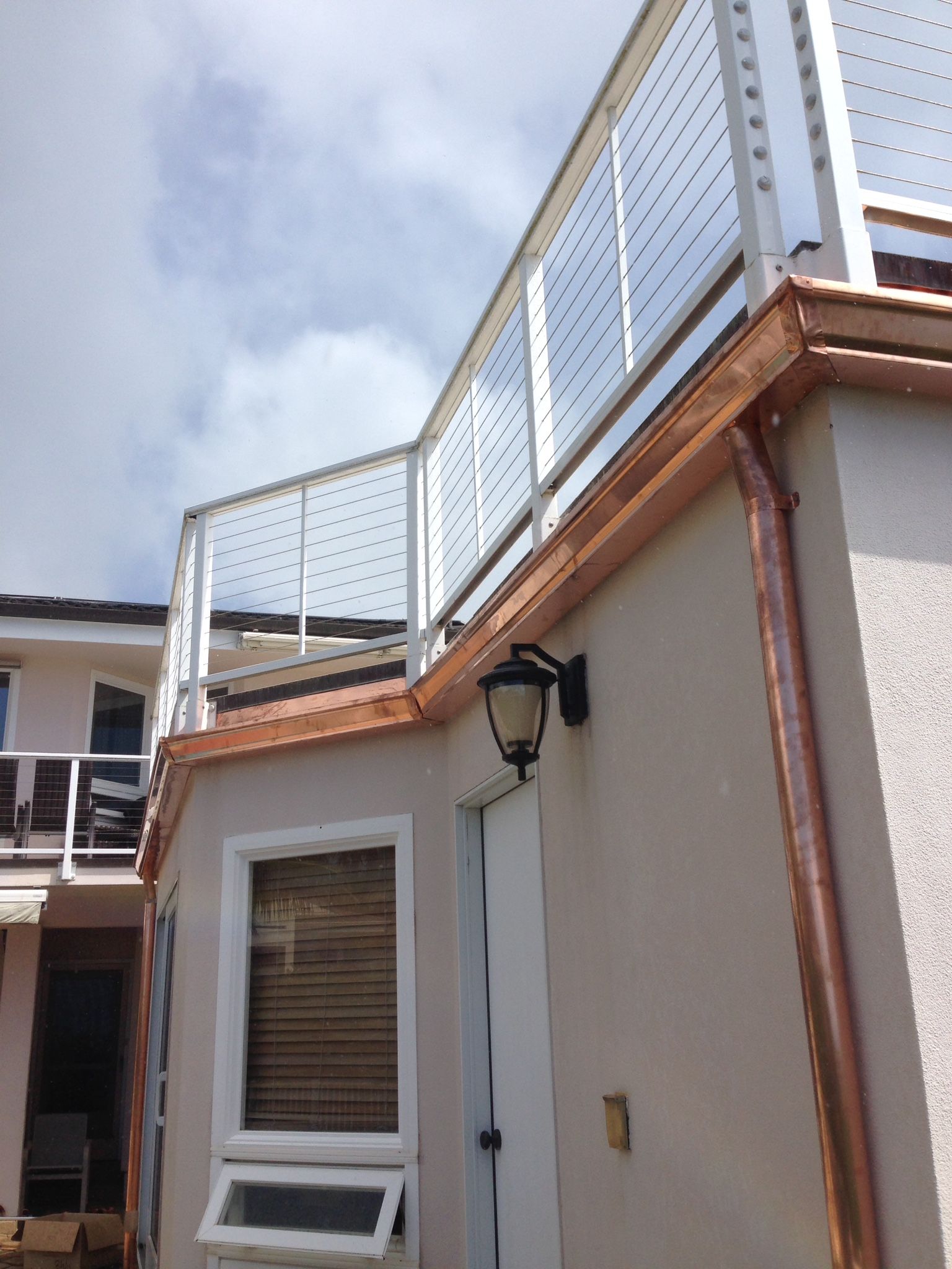 Balcony with a copper gutter on the side of a building