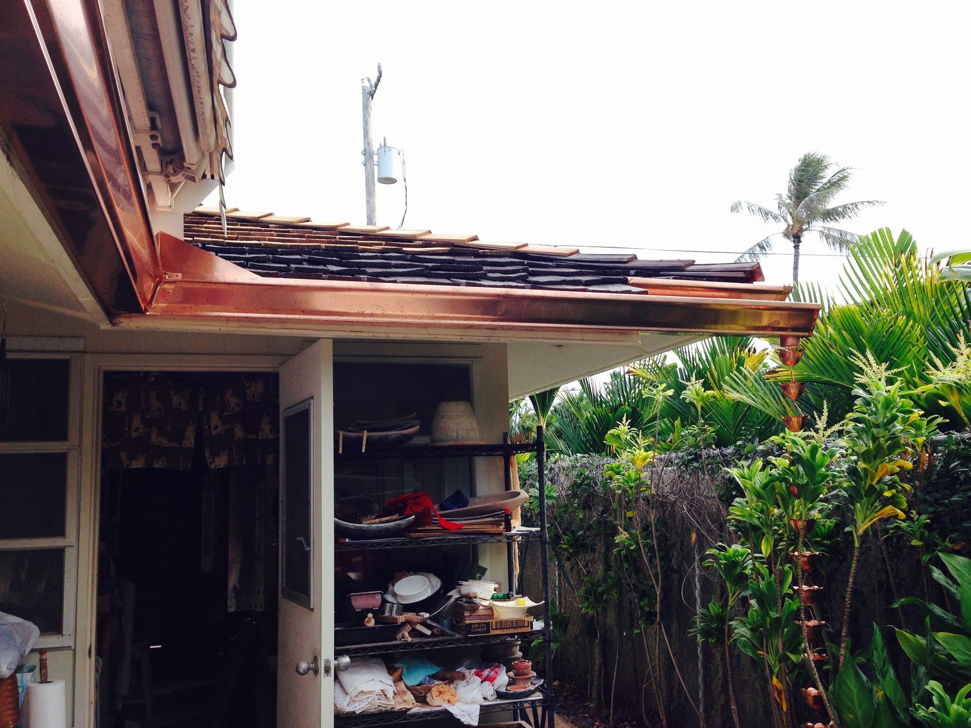 Garage with a door open and a shelf with items in it