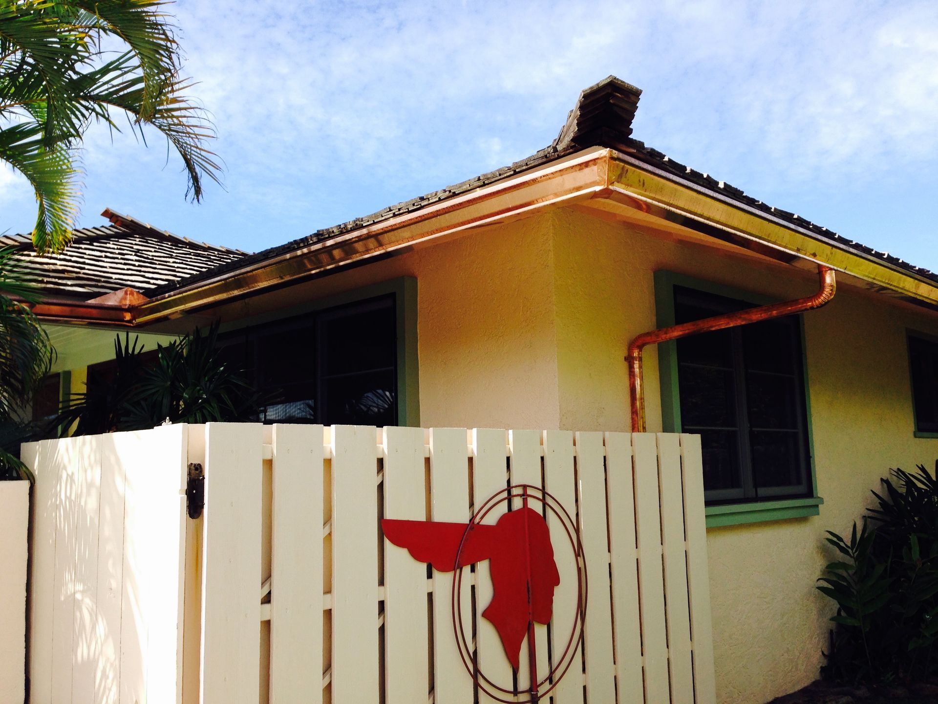 White fence with a red head on it