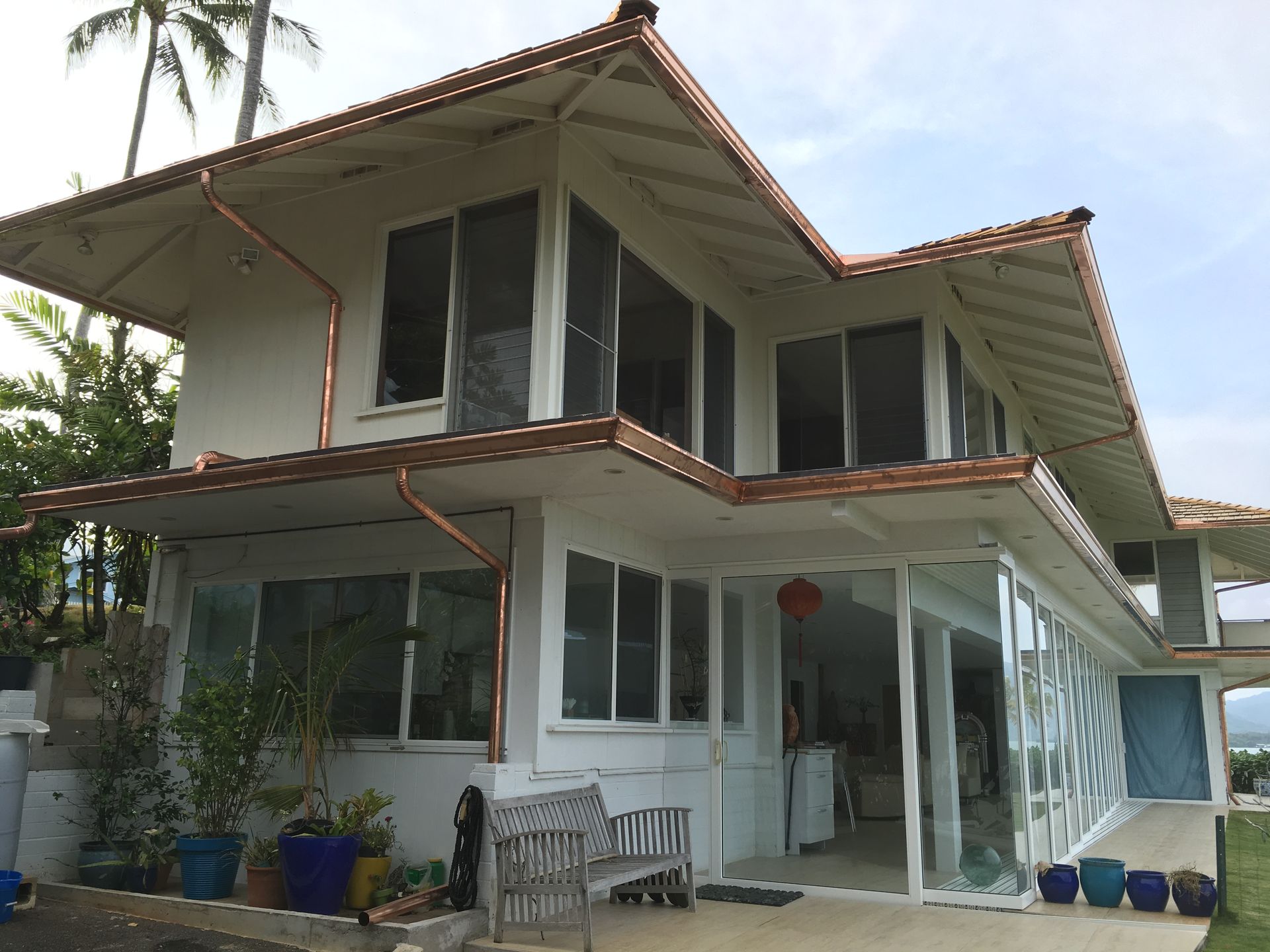 House with a glass wall and a wood deck