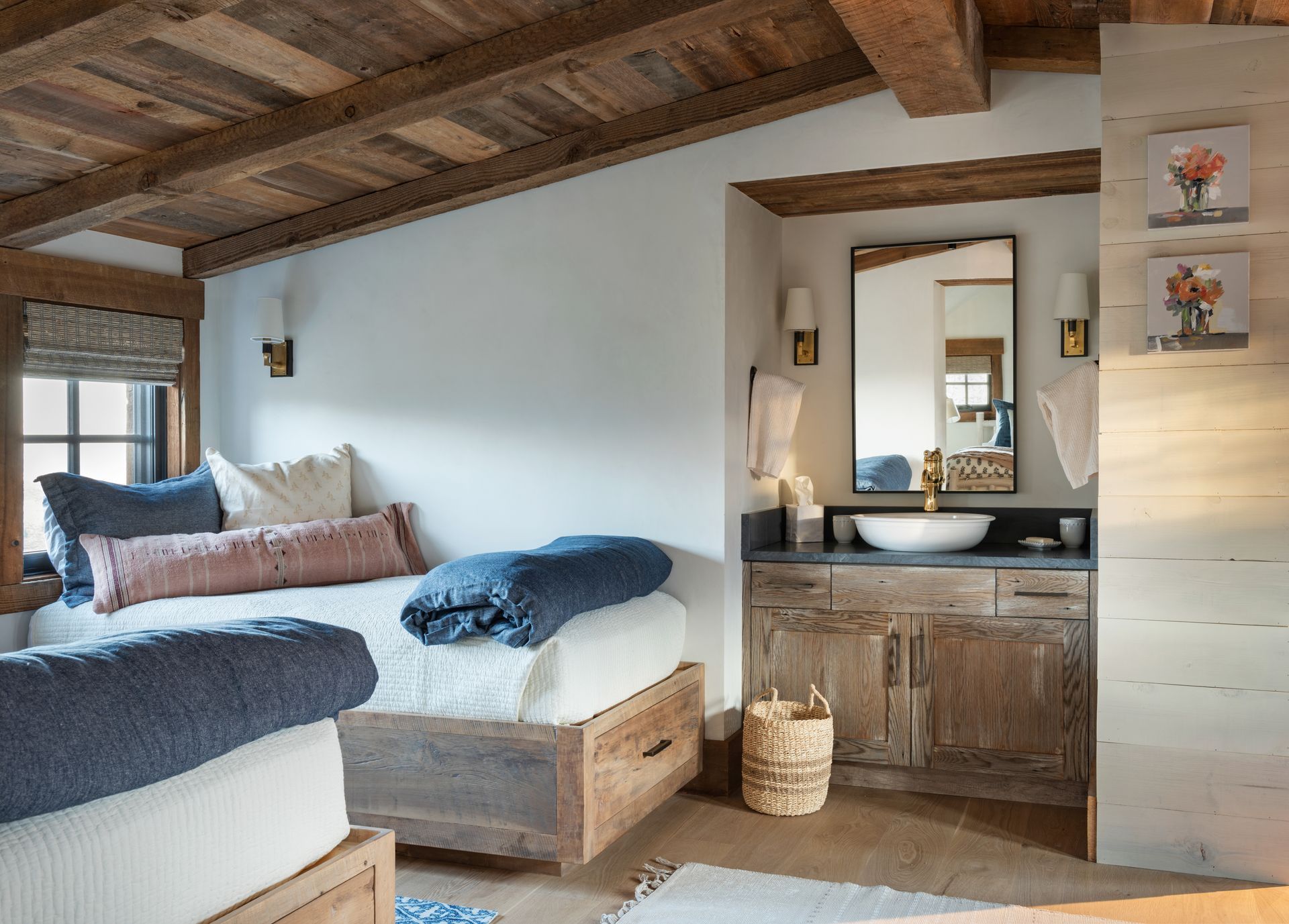 Rustic bedroom with wood ceiling, built-in beds, and bathroom vanity.