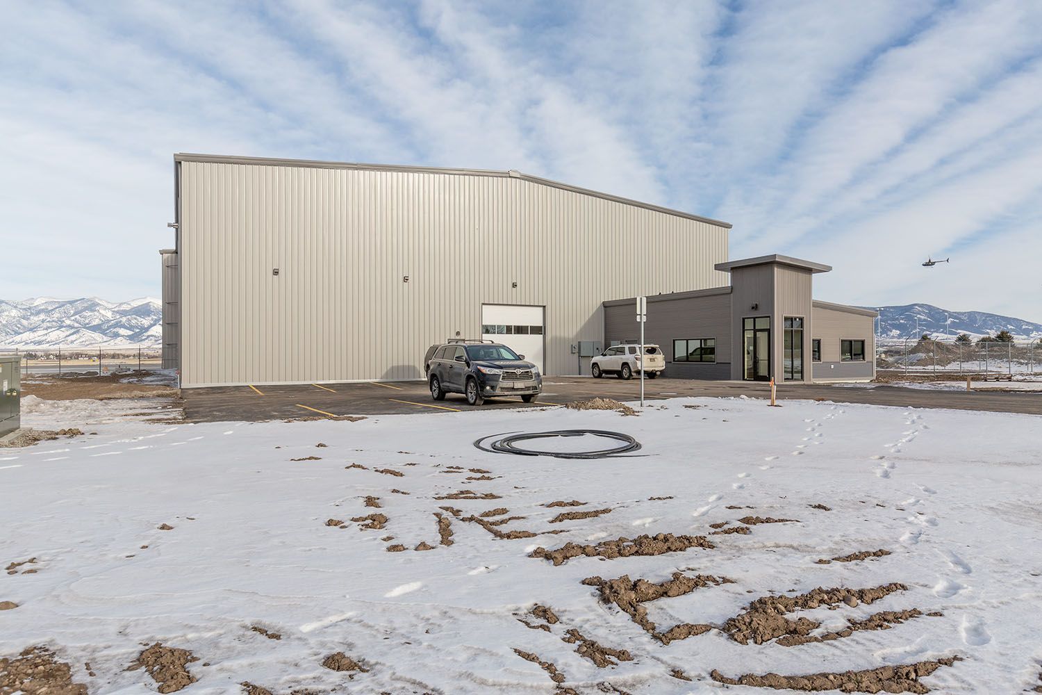 A commercial warehouse with metal siding and an attached grey office