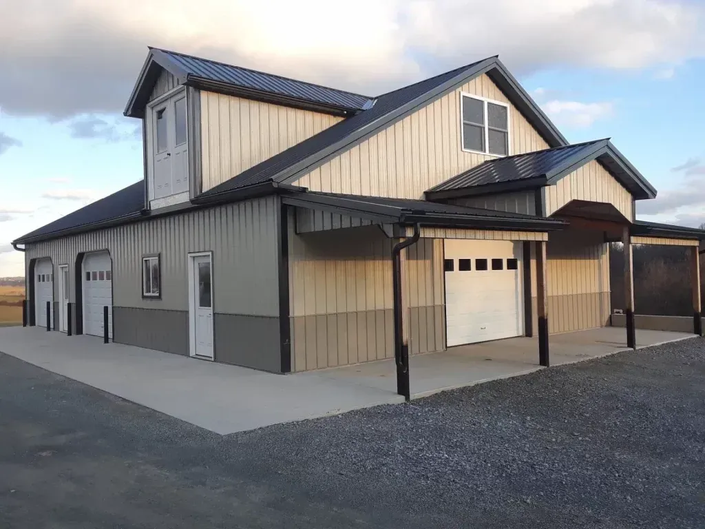 A large building with a black roof and a white garage door