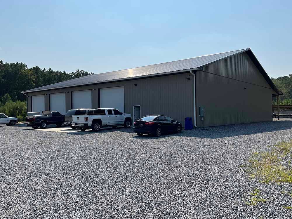 A large building with a lot of cars parked in front of it.
