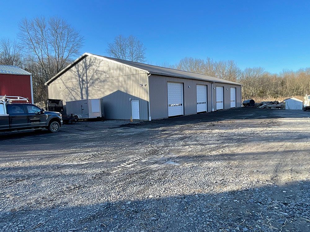 A truck is parked in front of a large building.