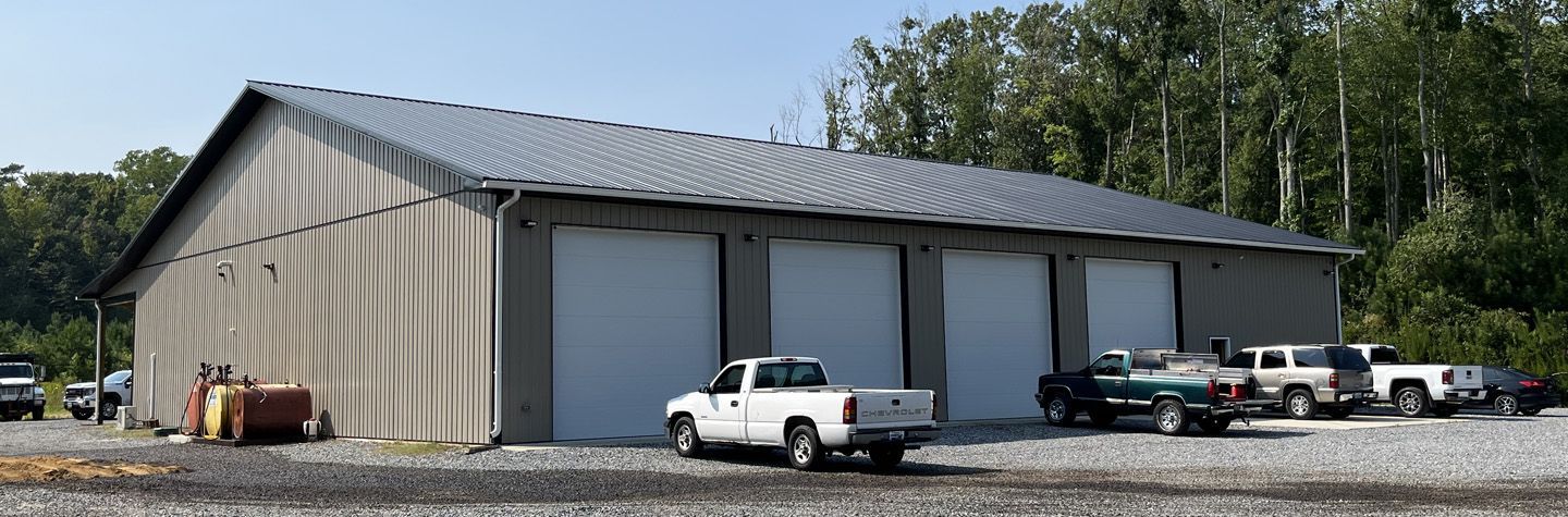 A white truck is parked in front of a large building.
