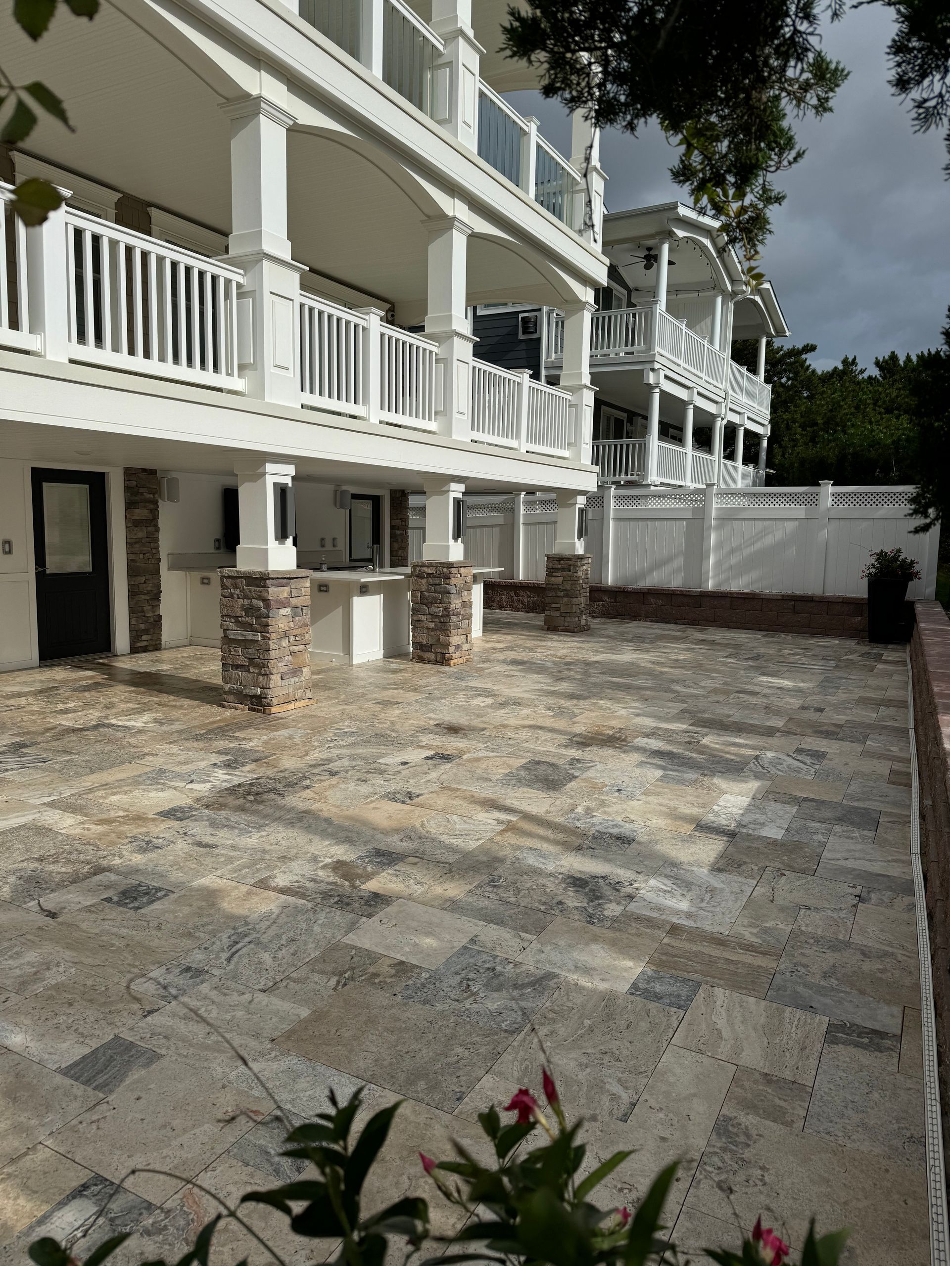 A large white building with a patio in front of it