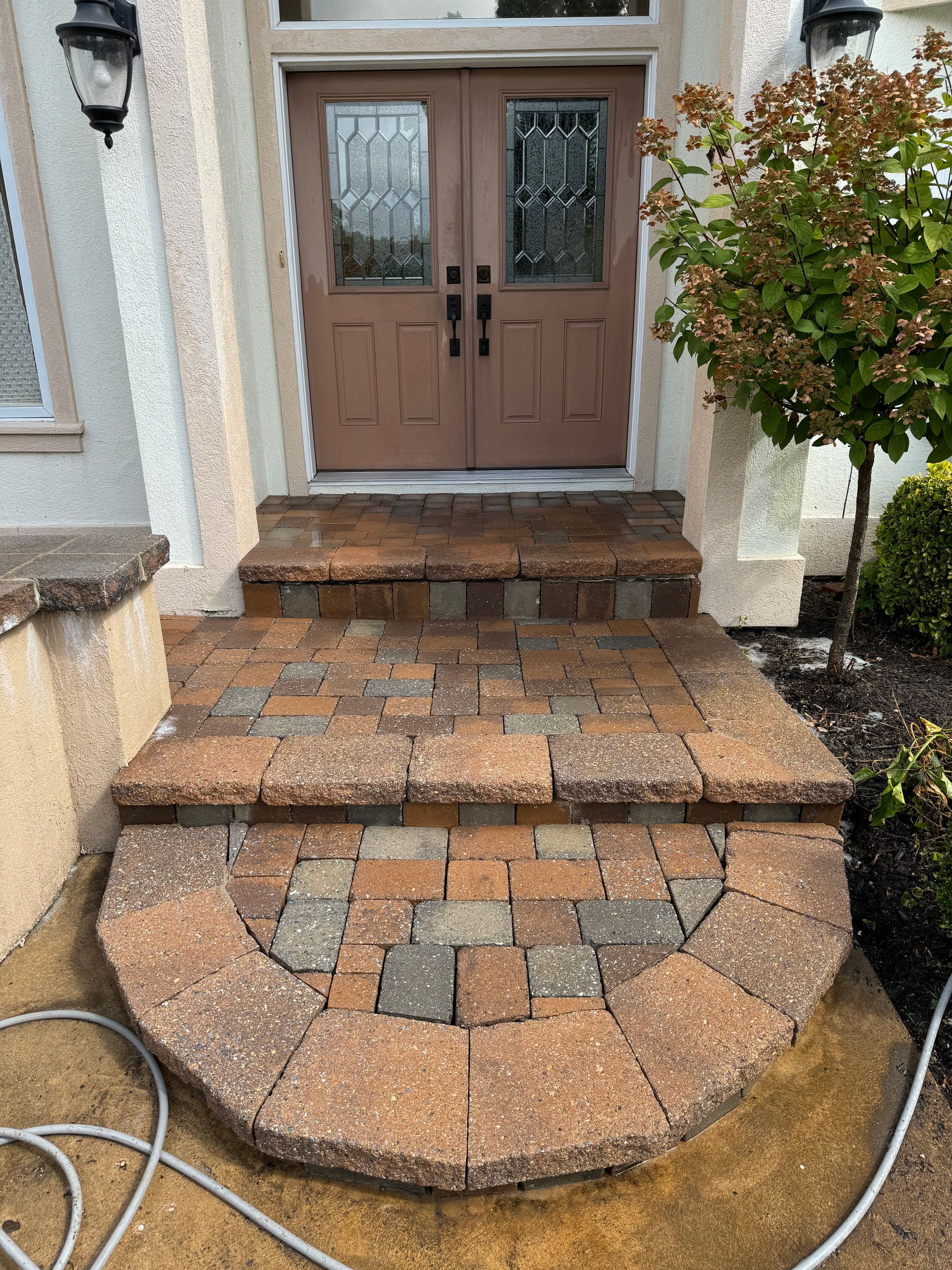 A brick walkway leading to the front door of a house.