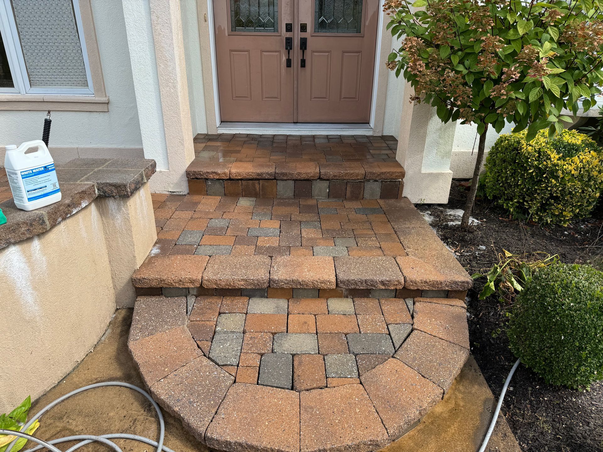 A brick walkway leading to the front door of a house.