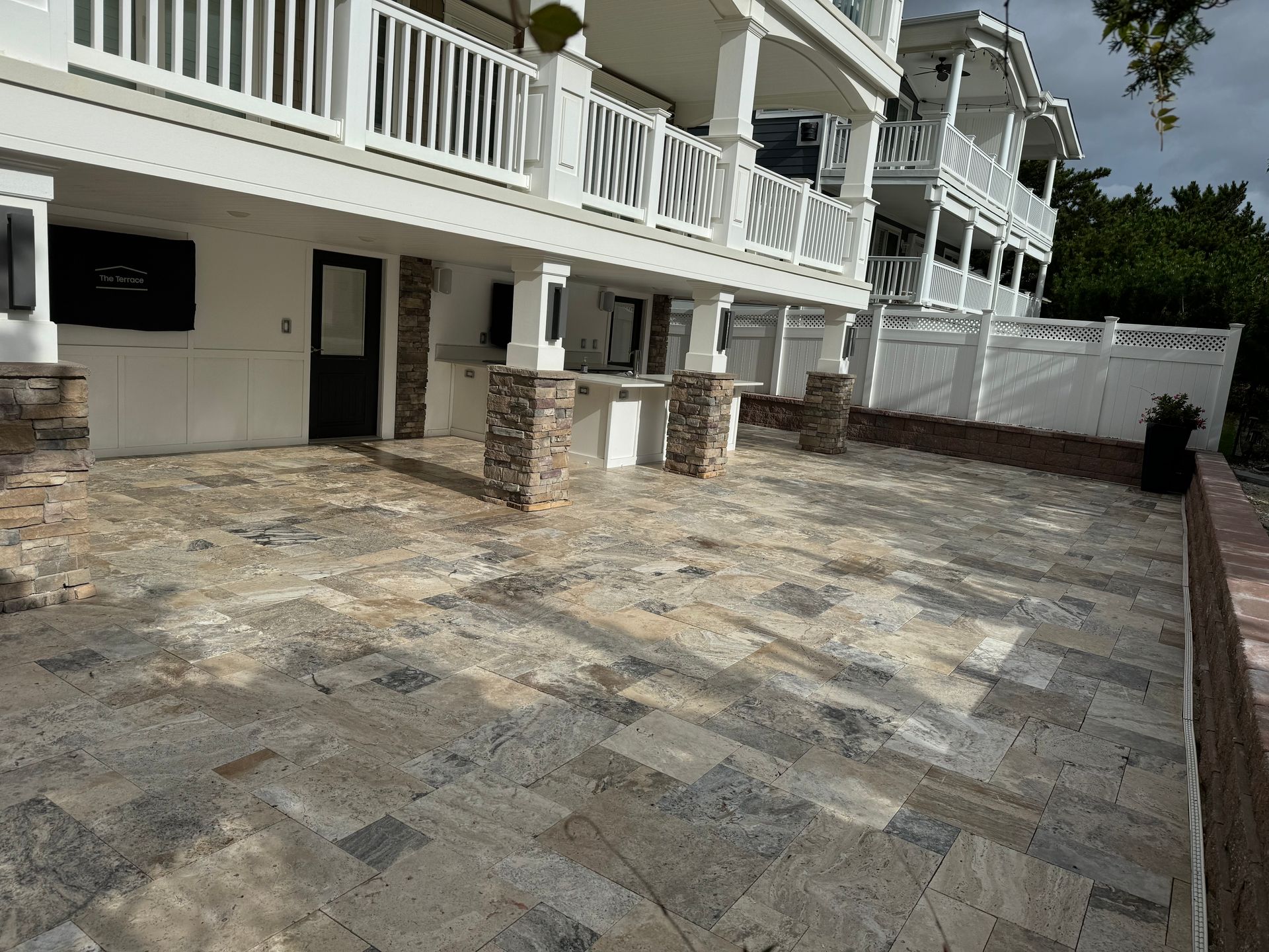 A large white house with a patio in front of it