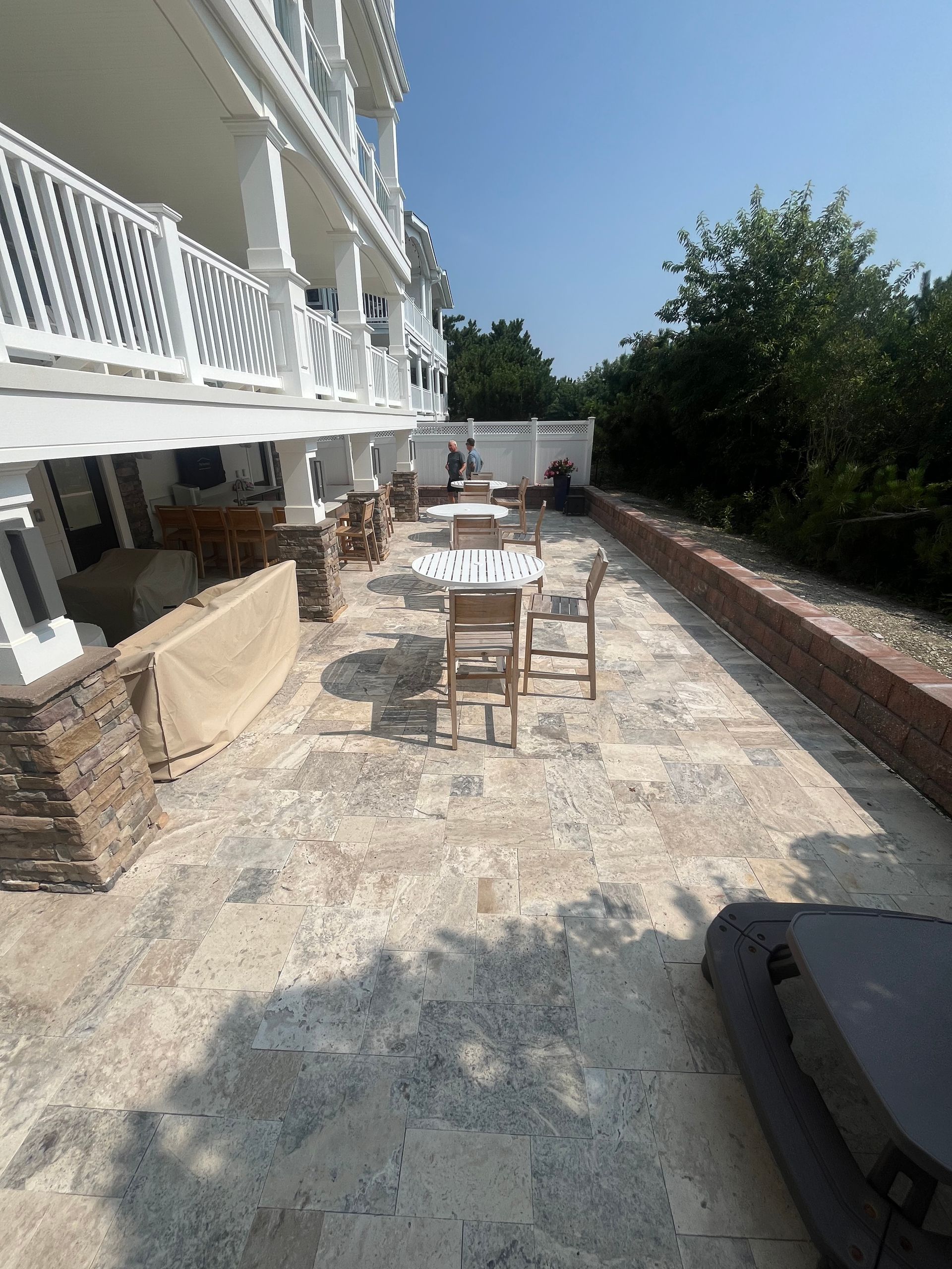 A patio with tables and chairs in front of a building.