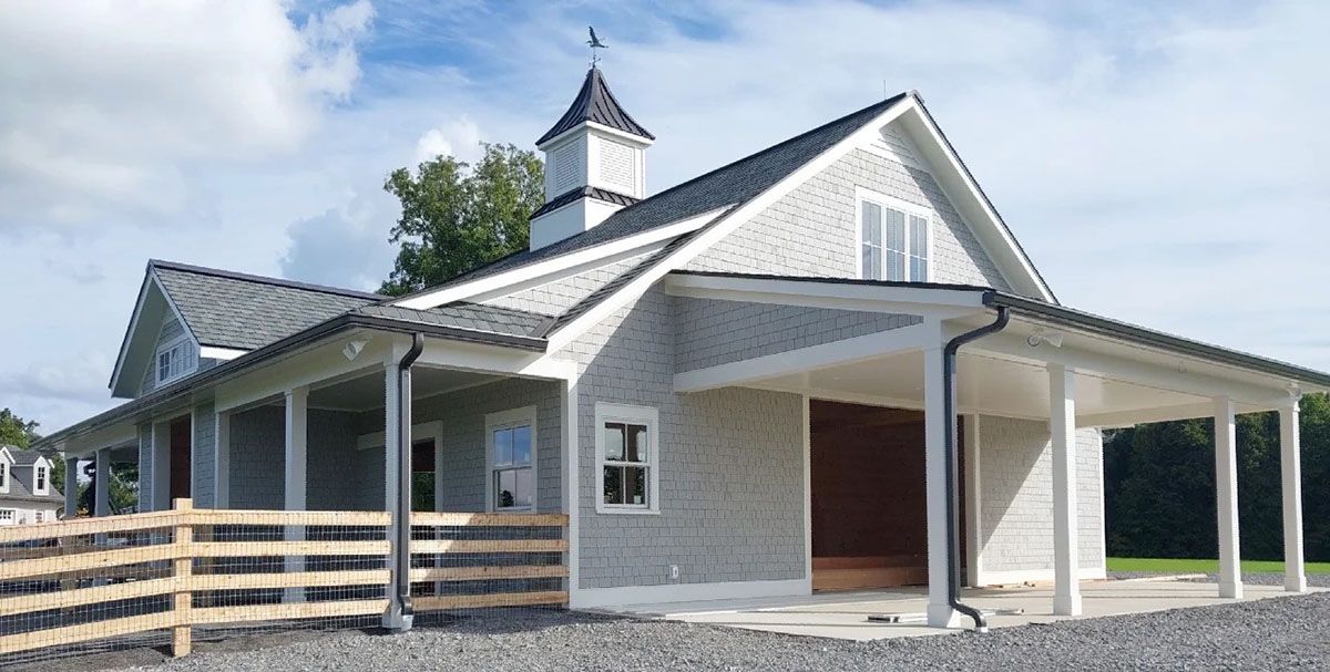 A large white house with a newly installed gutters